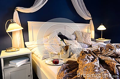 Rumpled sheets hotel bedroom romantic night Stock Photo