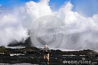 Run away from giant splashing waves Editorial Stock Photo