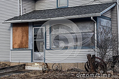 Run Down Screened Porch with Wagon Wheels Stock Photo