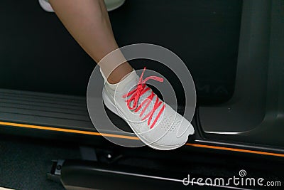 run shoes on treadmill rest foot side bar in dark theme Stock Photo