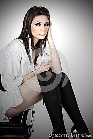 Runaway Teenager Sitting on her Suitcase Stock Photo