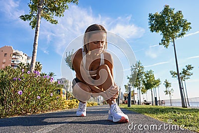 runner with ankle injury holds foot to reduce pain. running problem for athlete training outdoors Stock Photo