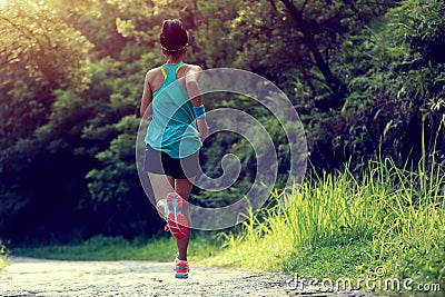 Runner athlete running on forest trail Stock Photo