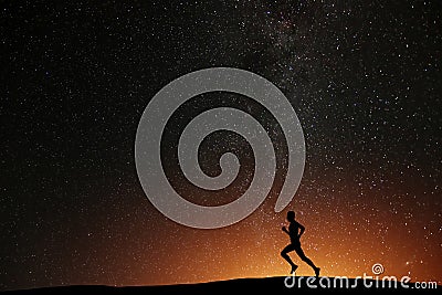 Runner athlete running on the hill with beautiful starry night Stock Photo