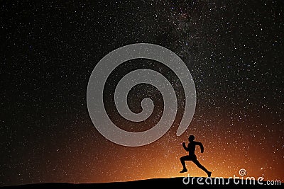 Runner athlete running on the hill with beautiful starry night Stock Photo