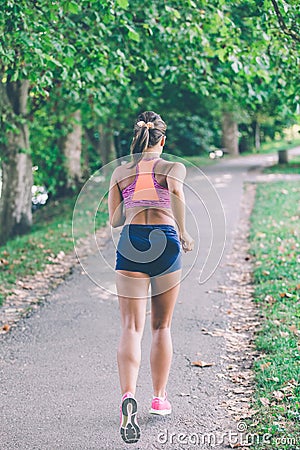 Runner athlete running at park. woman fitness jogging workout wellness concept. Stock Photo