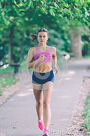 Runner athlete running at park. woman fitness jogging workout wellness concept. Stock Photo