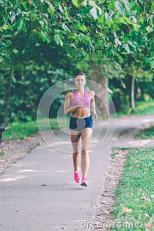 Runner athlete running at park. woman fitness jogging workout wellness concept. Stock Photo