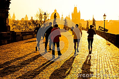 Runner athletes have morning jogging workout on Charles Bridge in Prague, Czech Republic. Healthy lifestyle and active Editorial Stock Photo