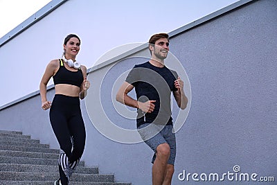 Runner athletes running on stairs. Couple fitness is jogging oudoors Stock Photo