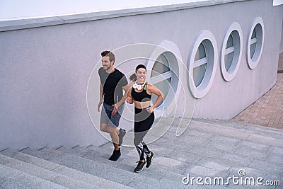 Runner athletes running on stairs. Couple fitness is jogging oudoors Stock Photo