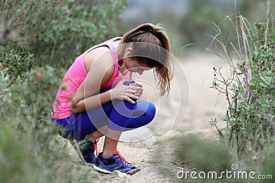 Runner complaining suffering knee ache outdoors Stock Photo