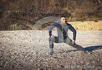 Runner doing stretching exercise Stock Photo