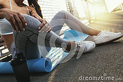 Runner with injury holds leg to reduce pain. Stock Photo