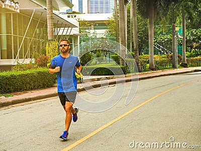 Runner man. Health and fitness outdoor concept. Man is runing in the morning and runing in a park Editorial Stock Photo