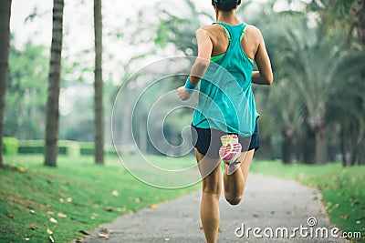 Runner running on tropical park trail Stock Photo