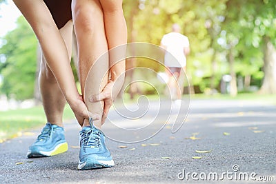 Runner touching painful twisted or broken ankle. Athlete runner training accident. Sport running ankle sprained sprain cause injur Stock Photo