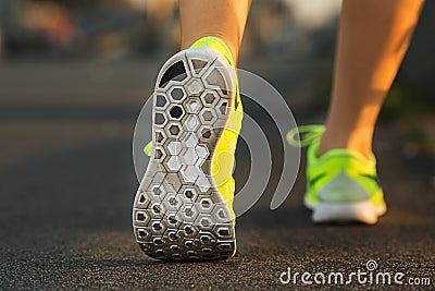 Runner woman feet running on road closeup on shoe. Female fitness model sunrise jog workout. Sports lifestyle concept. Stock Photo