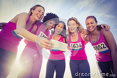 Runners supporting breast cancer marathon and taking selfies Stock Photo