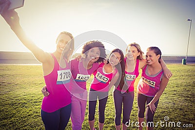 Runners supporting breast cancer marathon and taking selfies Stock Photo