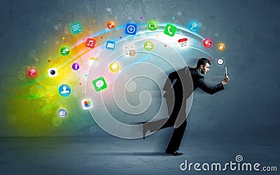 Running businessman with application icons from device Stock Photo