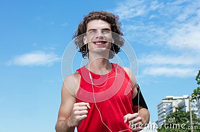 Running caucasian guy with long hair Stock Photo