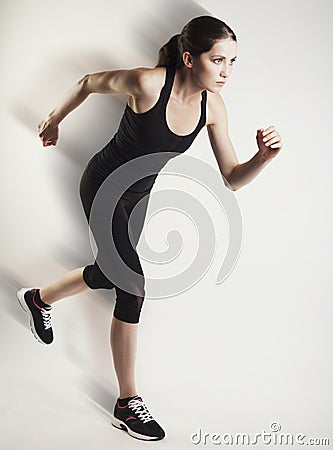 Running caucasian woman studio isolated on bg with blur motion s Stock Photo