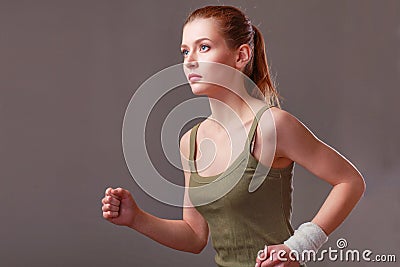 Running caucasian woman studio isolated on gray background Stock Photo