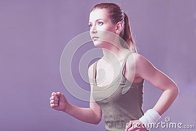 Running caucasian woman studio isolated on gray background Stock Photo