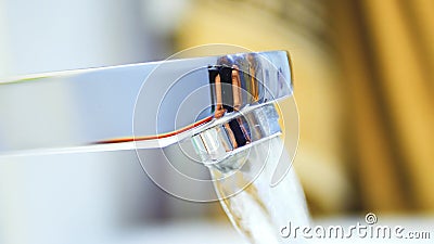 Running clear water from chrome faucet Stock Photo