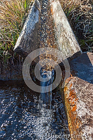 Running clear water to a trough Stock Photo