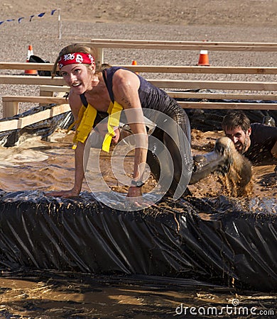 Running, Mud, and Obstacle Course Editorial Stock Photo