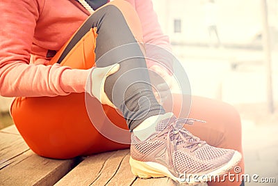 Running problem for athlete training outdoors. Runner sport knee injury. Athlete running clutching calf muscle after Stock Photo