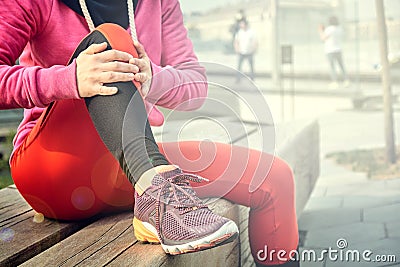 Running problem for athlete training outdoors. Runner sport knee injury. Athlete running clutching calf muscle after Stock Photo