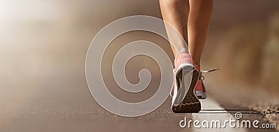 Running shoe closeup of woman running on road Stock Photo