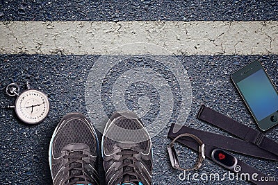 Running shoes and stopwatch. Hart rate sensor and watch whit pulse. Ready to run. Running on asphalt. Stock Photo