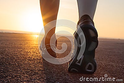 Running shoes in tarmac with sunset Stock Photo