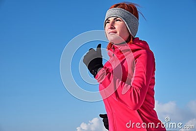 Running sport woman. Female runner jogging in cold winter forest wearing warm sporty running clothing and gloves Stock Photo