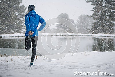 Running stretching. Athlete at the top of the mountain. Stock Photo