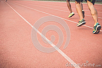 Running track with blur of runner feet in stadium Stock Photo