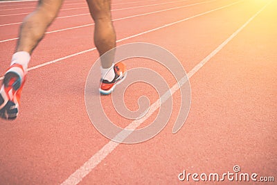 Running track with blur of runner feet in stadium Stock Photo