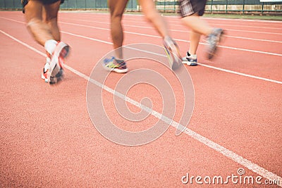 Running track with blur of runner feet in stadium Stock Photo