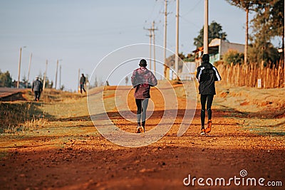 Running training in Kenya. A group of Kenyan runners prepare for a marathon and run on red soil. Marathon running, Track and Field Editorial Stock Photo