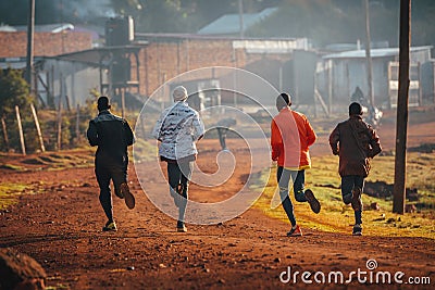 Running training in Kenya. A group of Kenyan runners prepare for a marathon and run on red soil. Marathon running, Track and Field Editorial Stock Photo