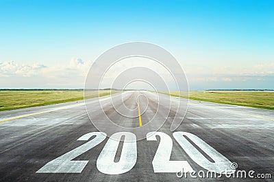 Runway asphalt road with the inscription 2020 year with blue sky. The concept of the beginning of new goals and affairs Stock Photo