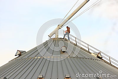 Rural American Man On Top Of Metal Grain Bin Editorial Stock Photo