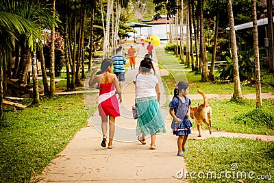 Rural asphalt road through the green field in the jungle, people Editorial Stock Photo