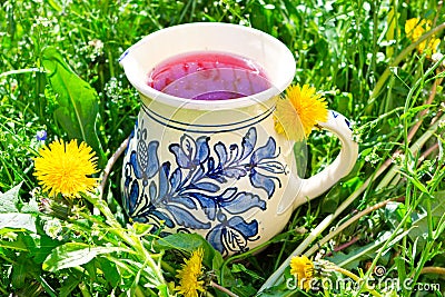 Rural clay jug filled with fruit drink Stock Photo