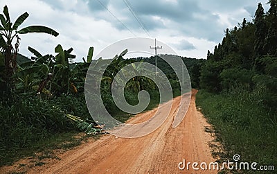 Rural dirt road to the mountains Stock Photo