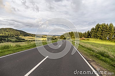 Rural Eifel landscape with road and green meadow Stock Photo